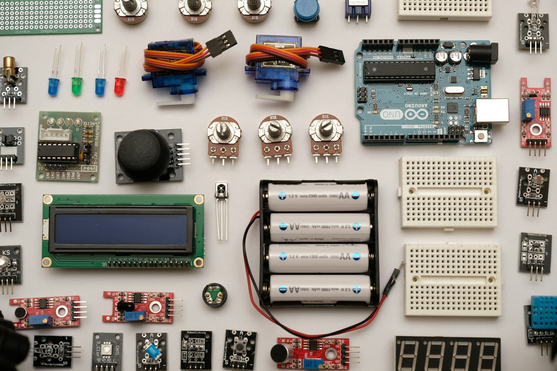 Sensors, boards and electronic parts laid out on a white table
