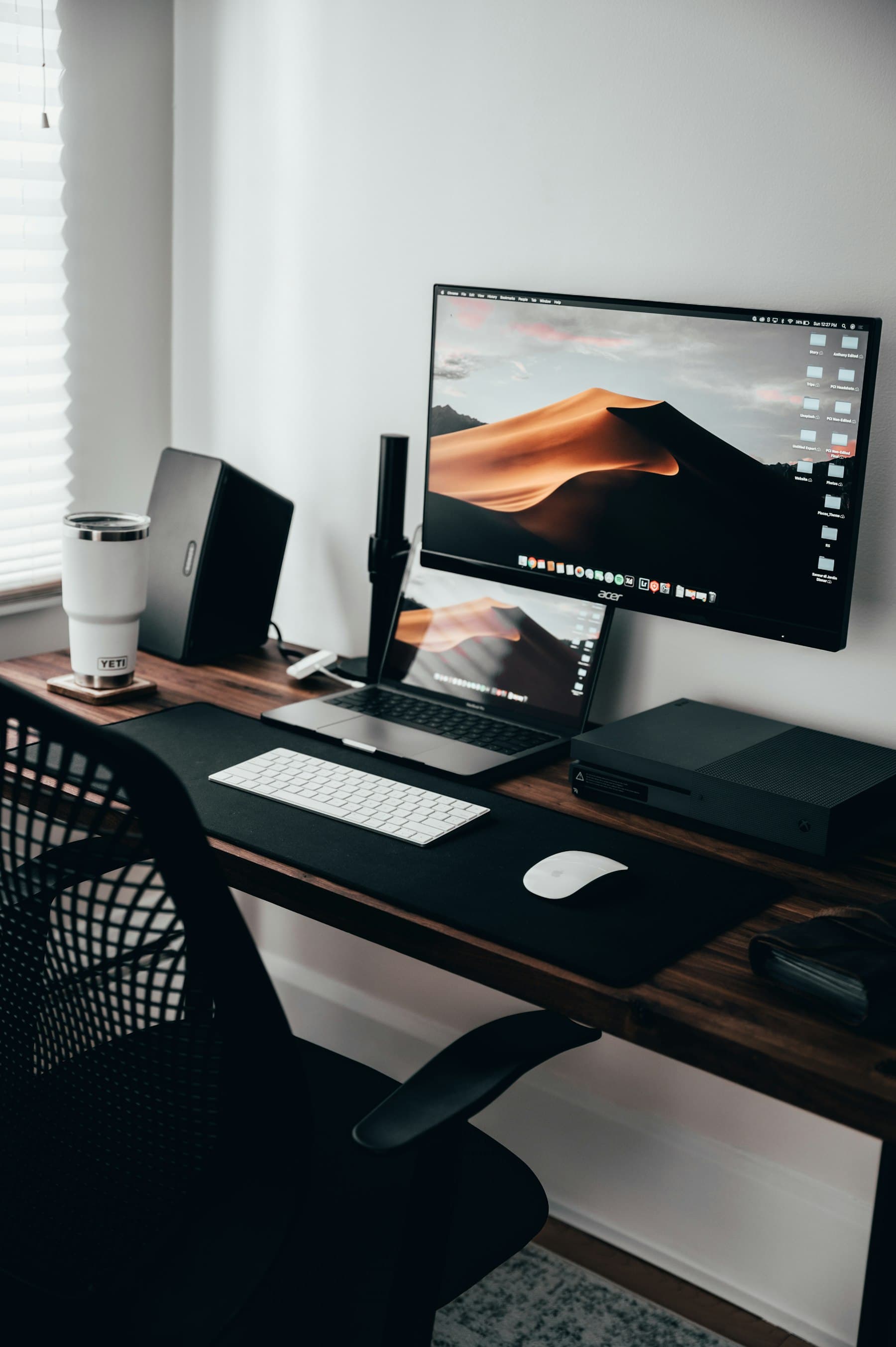 A desk with a laptop, a monitor and a keyboard